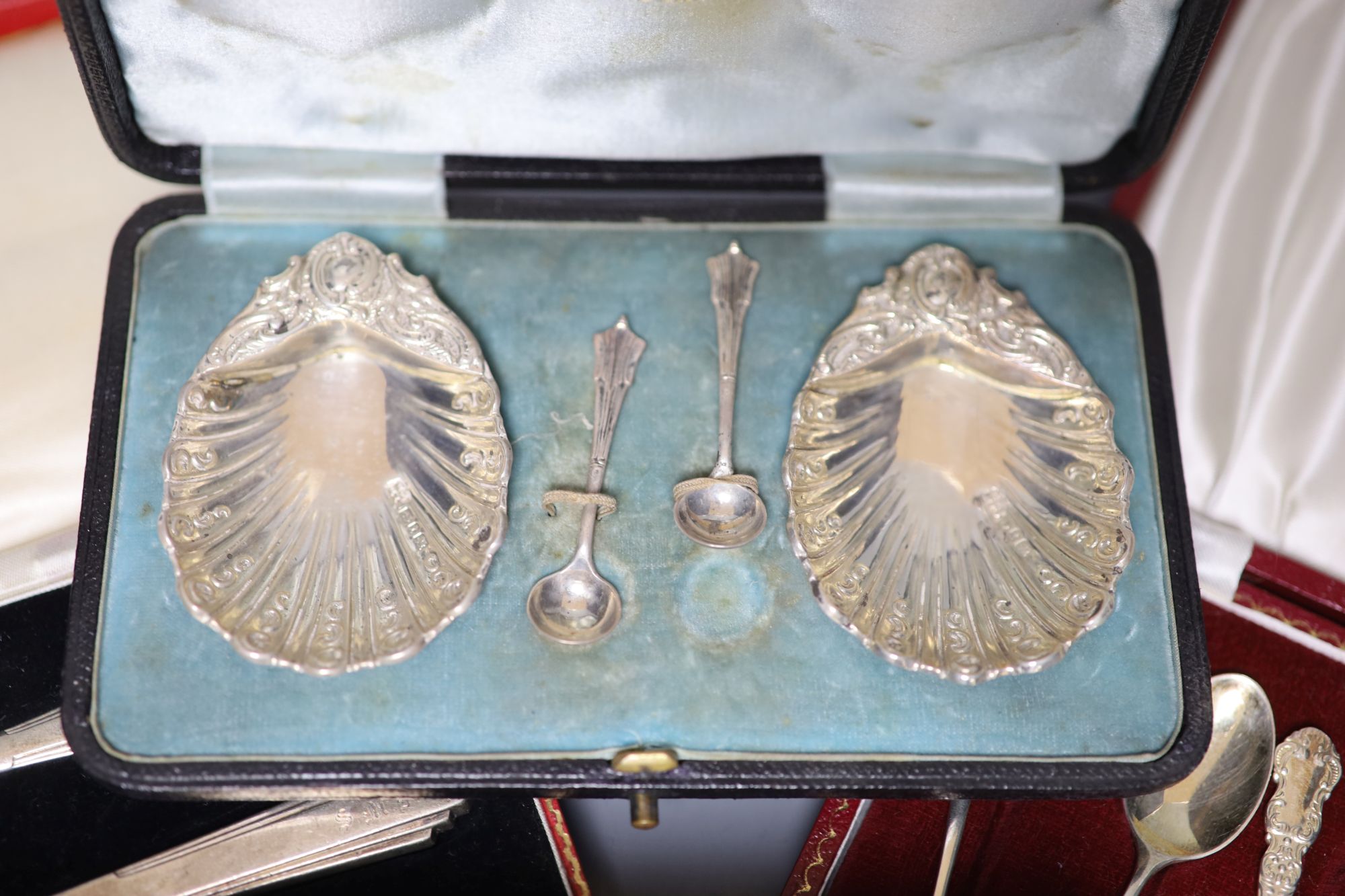 A pair of silver dwarf candlesticks and various cased silver items,